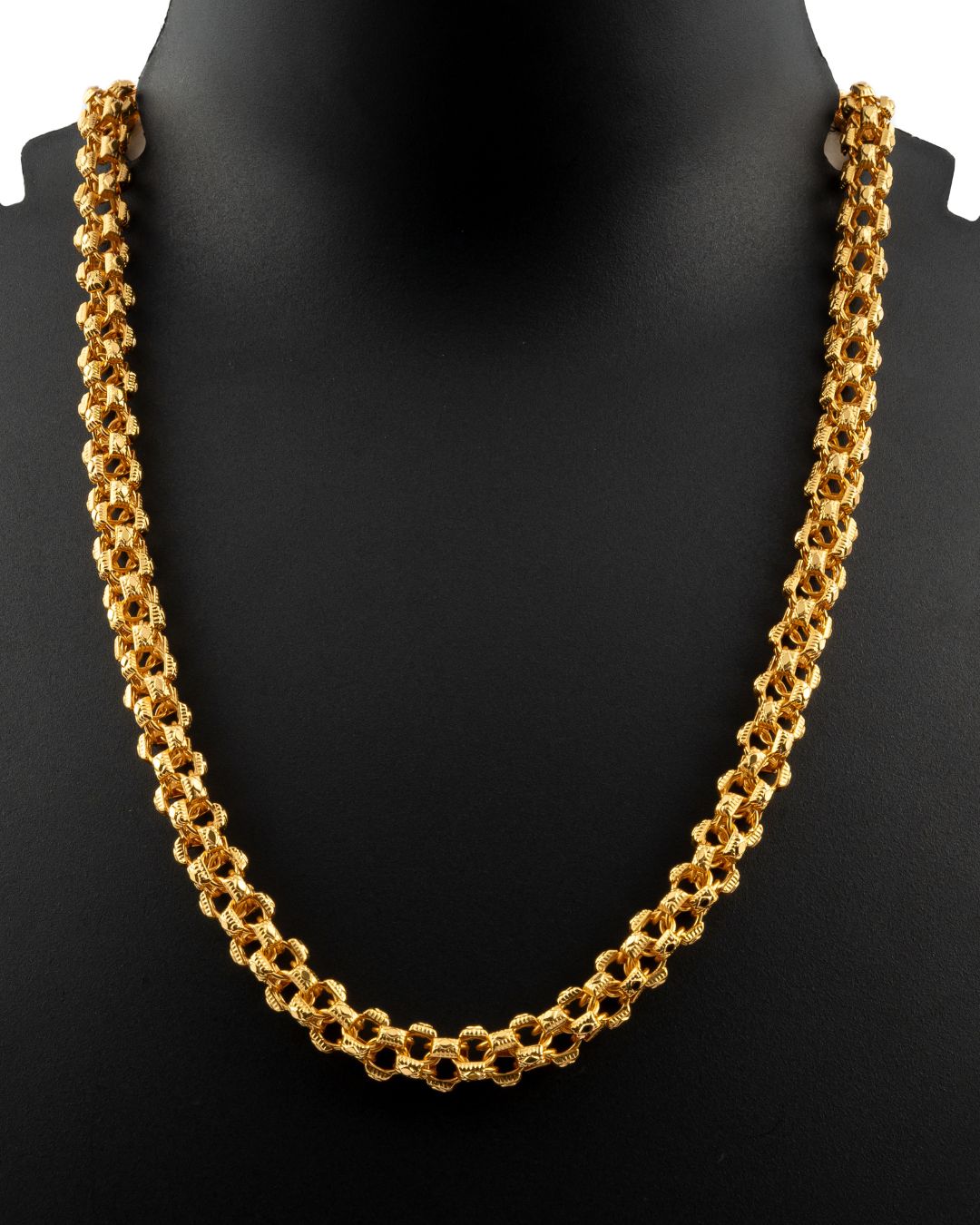 Gold chain necklace on a black mannequin