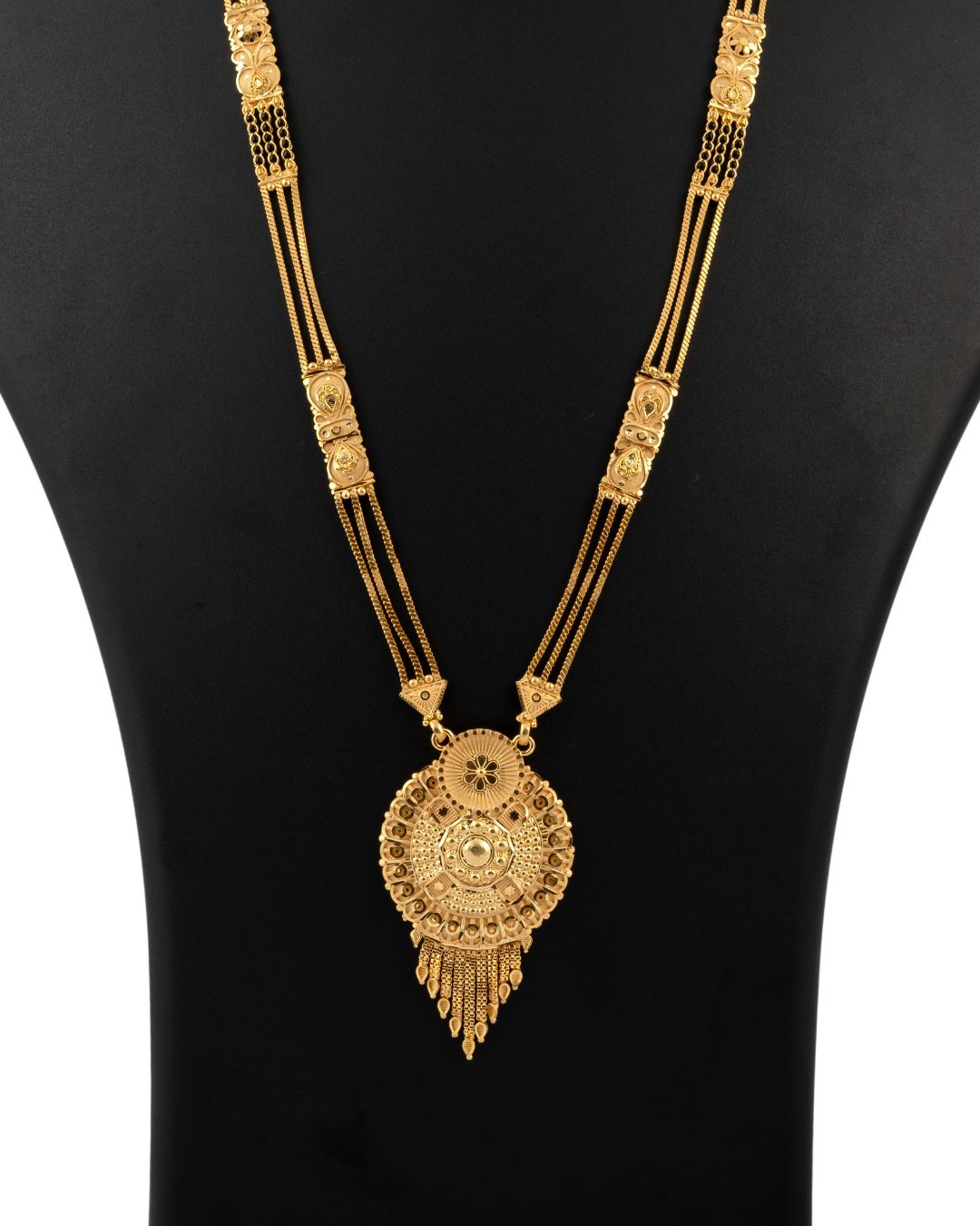 Gold necklace with intricate design on a black background