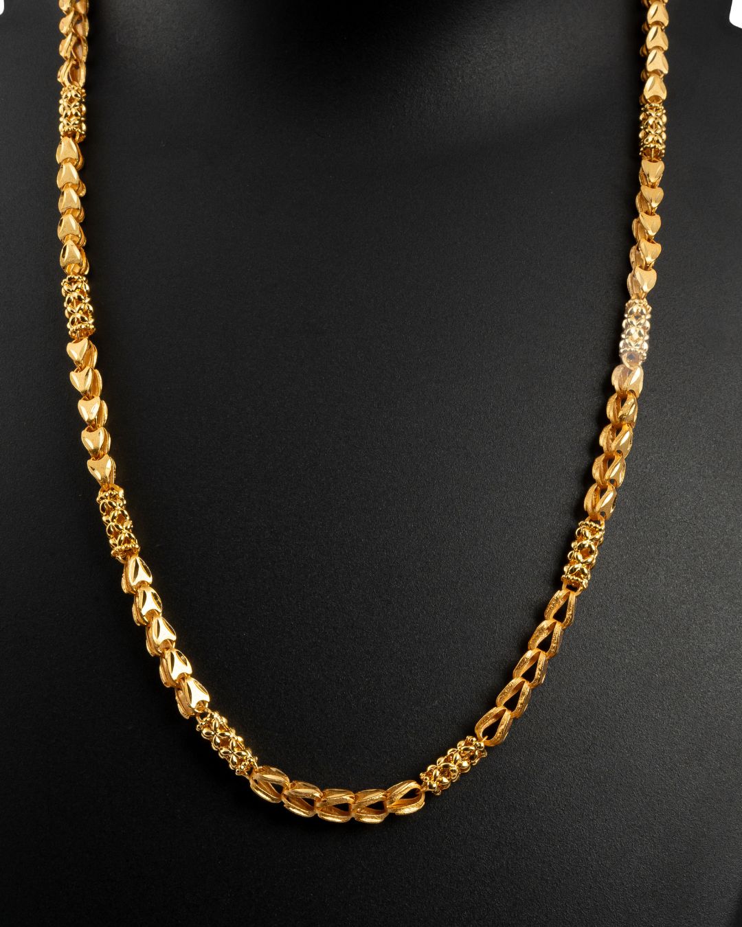 Gold chain necklace on a black background