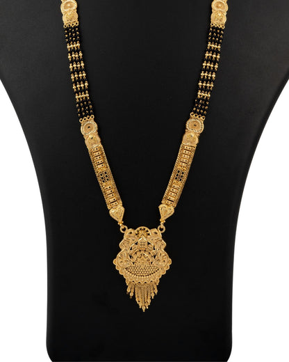 Gold necklace with a pendant on a black mannequin