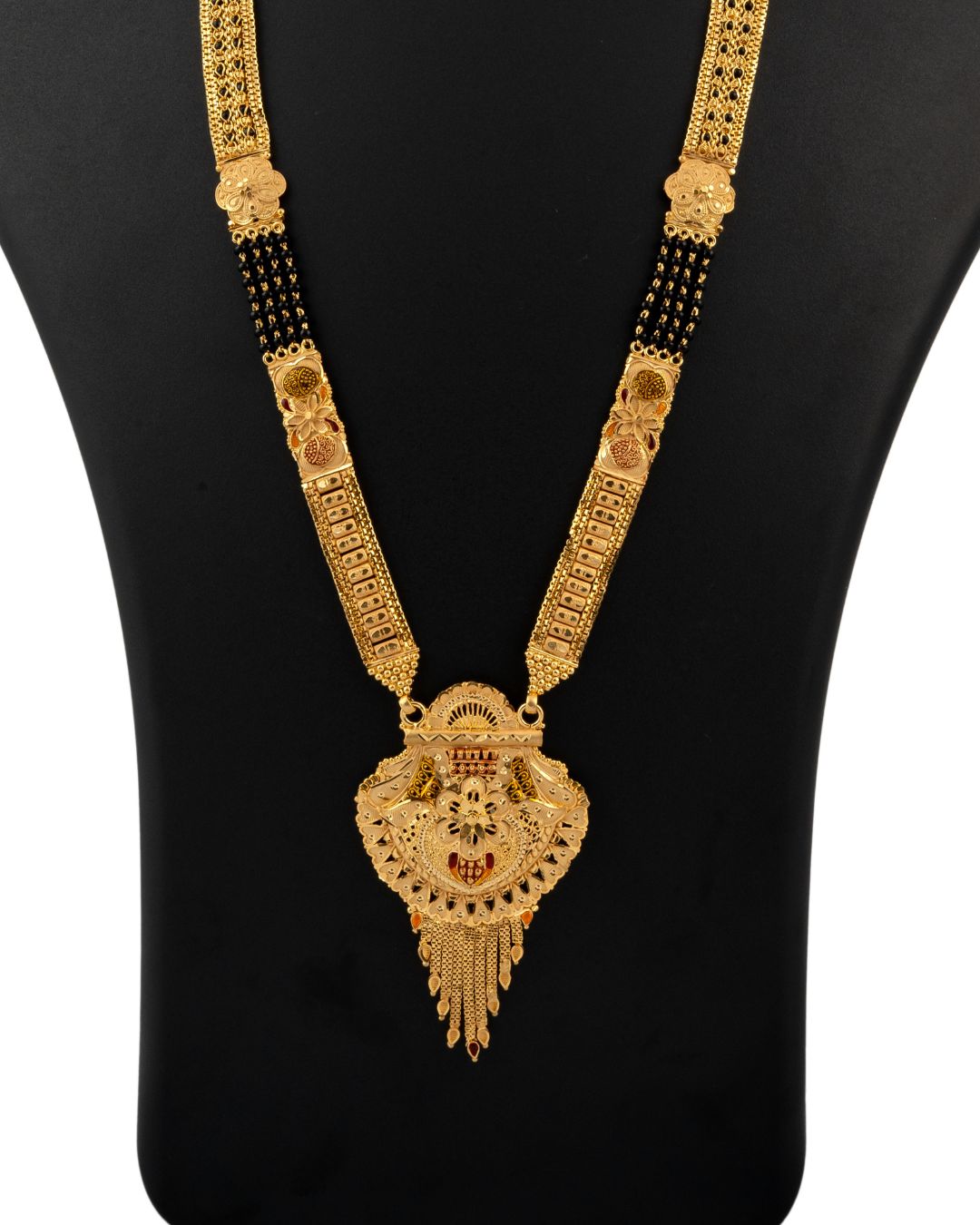 Gold necklace with intricate design on a black background