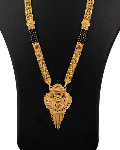 Gold necklace with intricate design on a black background