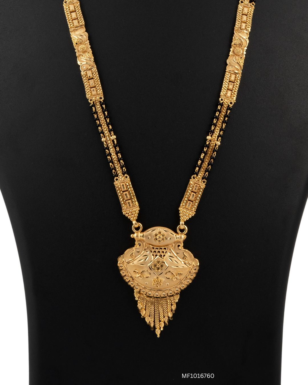 Gold necklace with intricate design on a black background