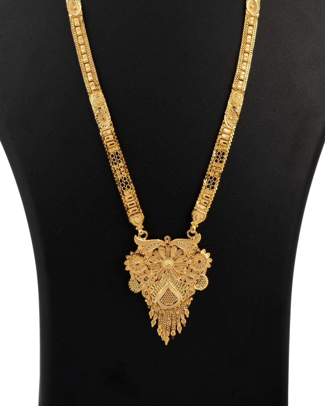 Gold necklace with intricate design on a black background