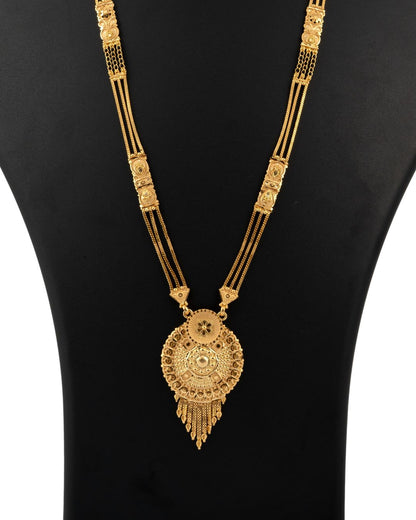 Gold necklace with intricate design on a black background