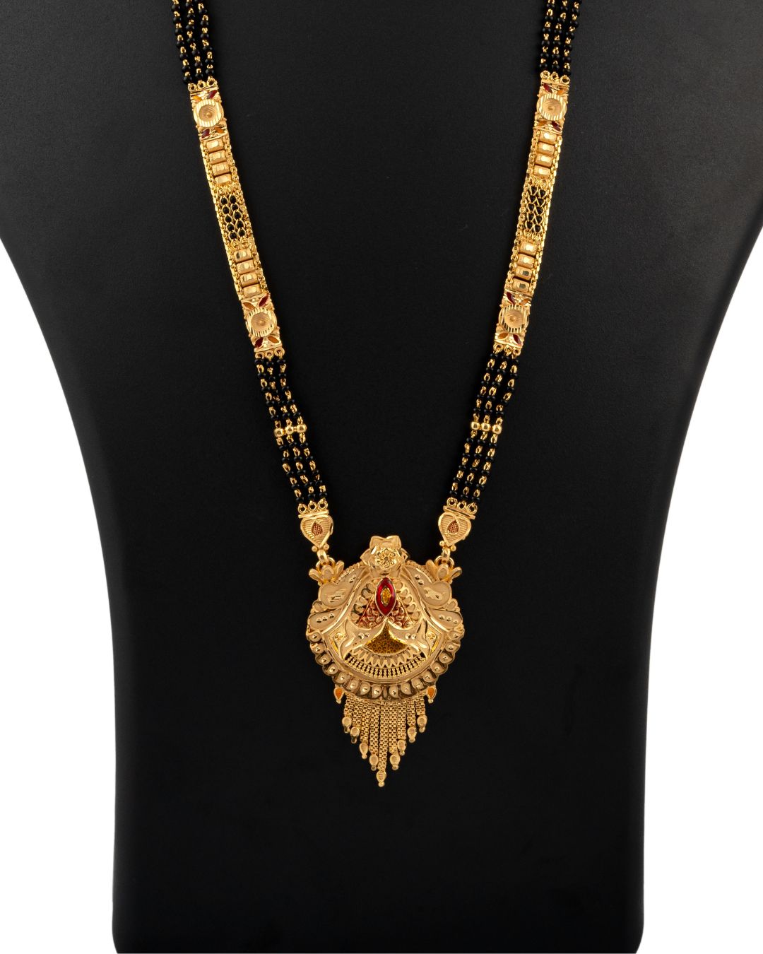 Gold necklace with a pendant on a black mannequin