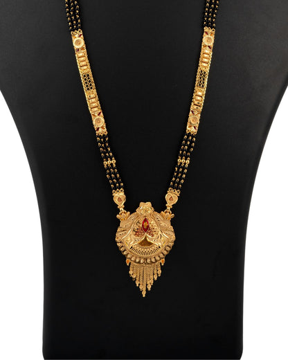Gold necklace with a pendant on a black mannequin