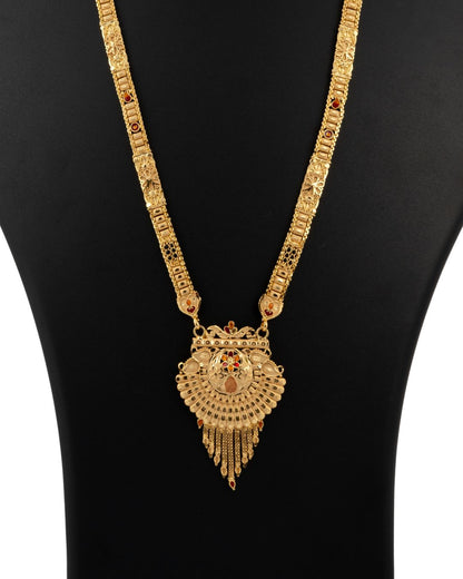Gold necklace with a heart-shaped pendant on a black background