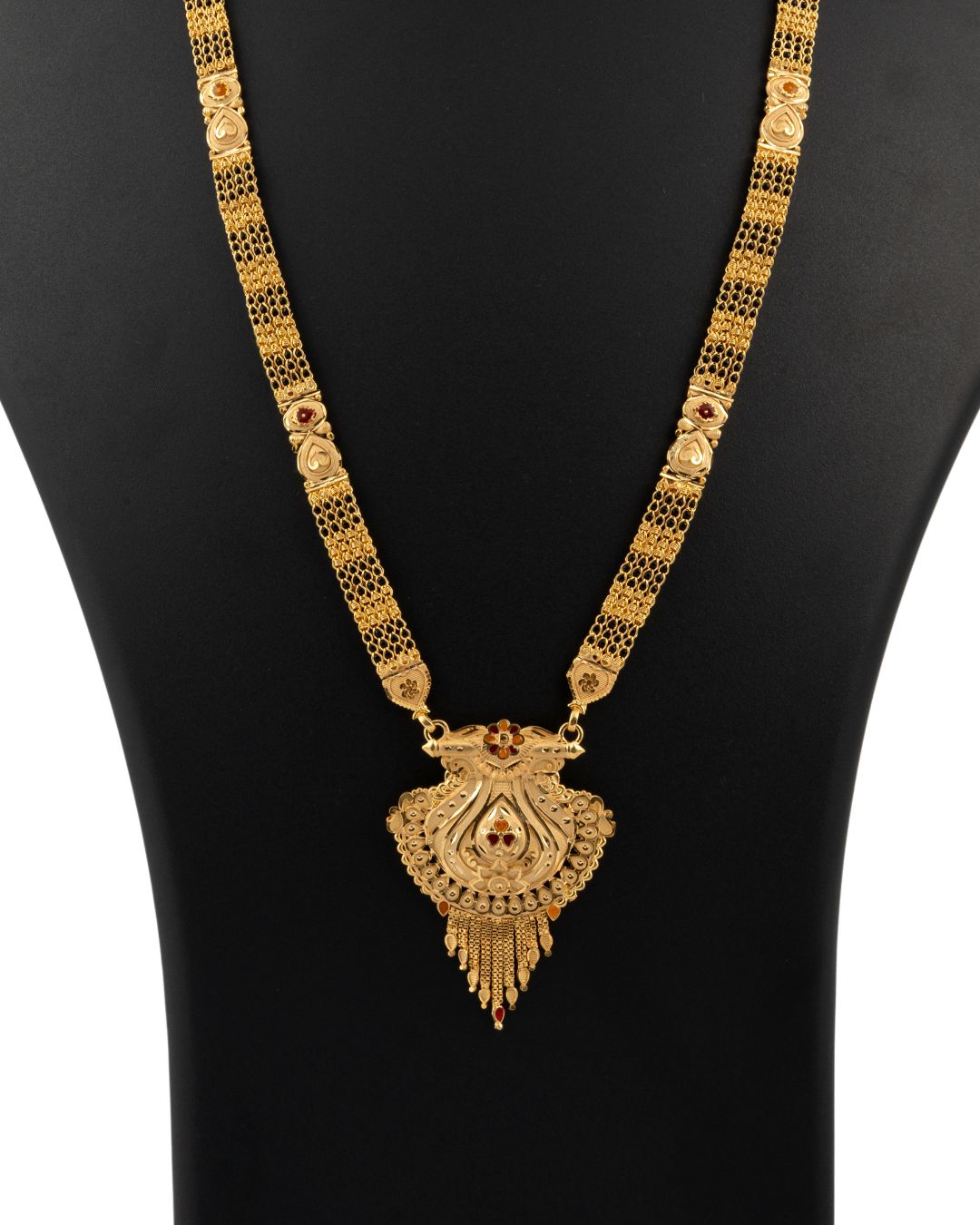 Gold necklace with a pendant on a black mannequin